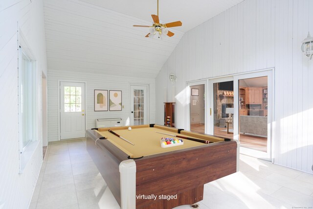recreation room with lofted ceiling, billiards, a ceiling fan, light tile patterned floors, and wood walls