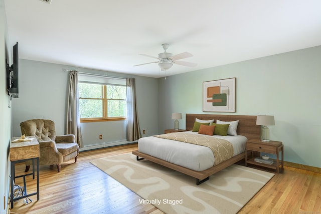 43 Roaring Brook Ln, Shelton, CT 06484 - bedroom with a baseboard heating unit, wood finished floors, baseboards, and ceiling fan