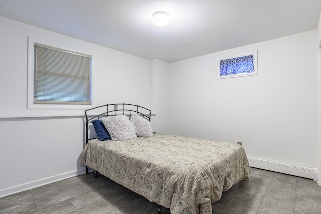 bedroom with a baseboard radiator and baseboards