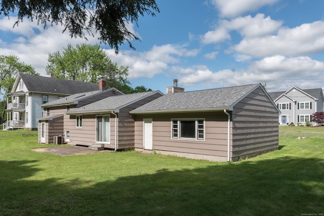 48 Warren St, Cheshire, CT 06410 - back of house featuring central AC, a yard, a chimney, and a shingled roof