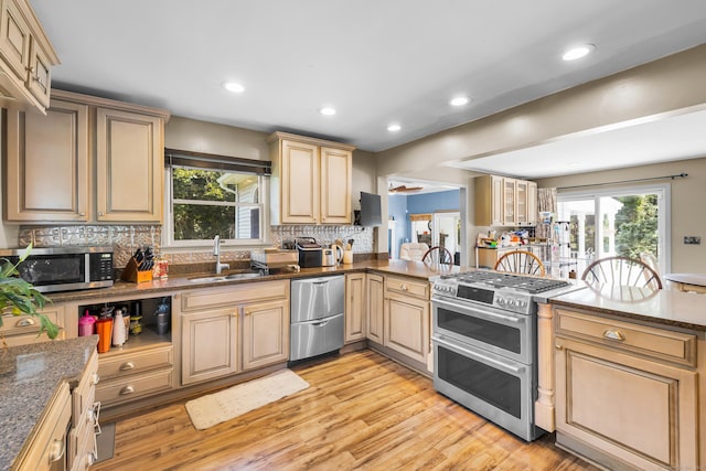 10 Harvard Ter, Norwich, CT 06360 - kitchen with appliances with stainless steel finishes, decorative backsplash, light wood-style floors, recessed lighting, and a peninsula