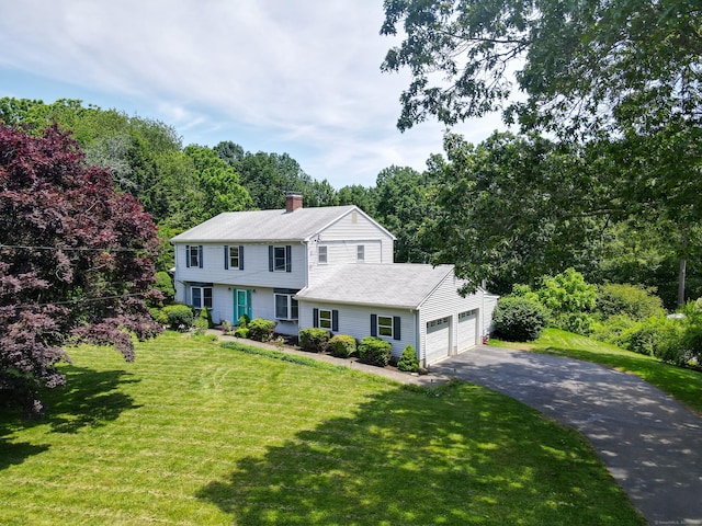 10 Harvard Ter, Norwich, CT 06360 - colonial-style house with asphalt driveway, a chimney, an attached garage, and a front yard