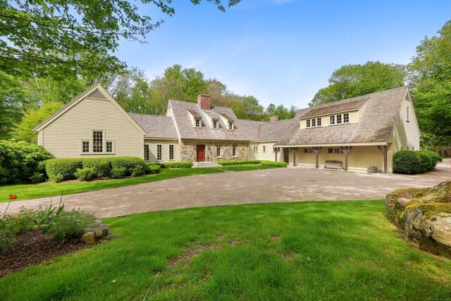 70 Sill Ln, Old Lyme, CT 06371 - view of front of property featuring a chimney, curved driveway, a front yard, and a garage