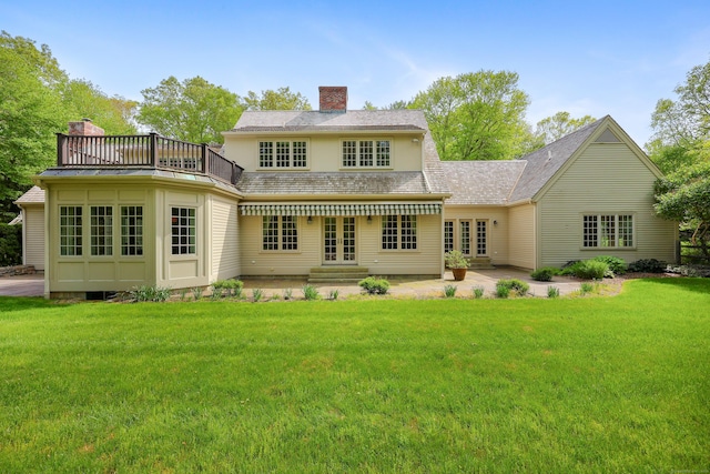 70 Sill Ln, Old Lyme, CT 06371 - back of property with french doors, a balcony, a chimney, and a lawn