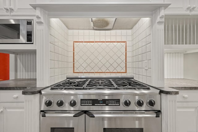 70 Sill Ln, Old Lyme, CT 06371 - kitchen view of appliances with stainless steel finishes, backsplash, white cabinetry, and dark countertops