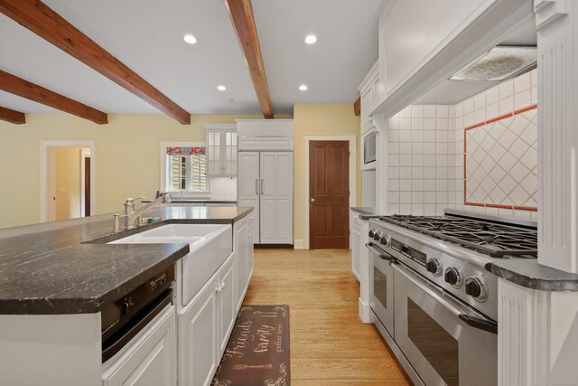 70 Sill Ln, Old Lyme, CT 06371 - kitchen with range with two ovens, a sink, decorative backsplash, beamed ceiling, and light wood finished floors
