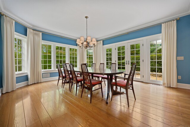 70 Sill Ln, Old Lyme, CT 06371 - dining area with french doors, a chandelier, hardwood / wood-style floors, and baseboards