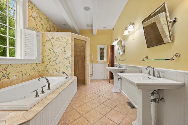 70 Sill Ln, Old Lyme, CT 06371 - bathroom featuring a jetted tub, a wainscoted wall, two sinks, and a tile shower