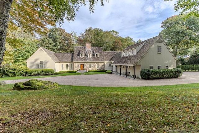 70 Sill Ln, Old Lyme, CT 06371 - view of front of home featuring a chimney, curved driveway, and a front lawn