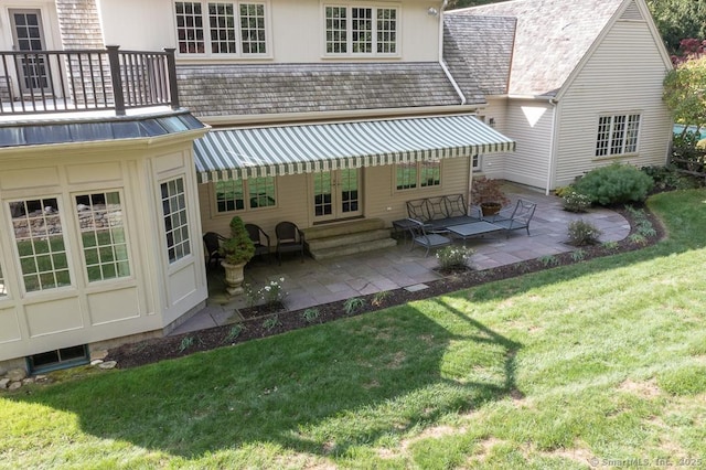 70 Sill Ln, Old Lyme, CT 06371 - rear view of house featuring a lawn, a patio, french doors, and a balcony