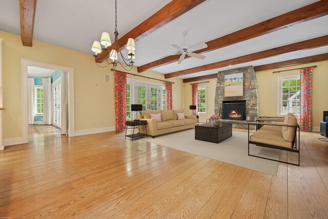 70 Sill Ln, Old Lyme, CT 06371 - living area with hardwood / wood-style flooring, beam ceiling, a stone fireplace, baseboards, and a ceiling fan