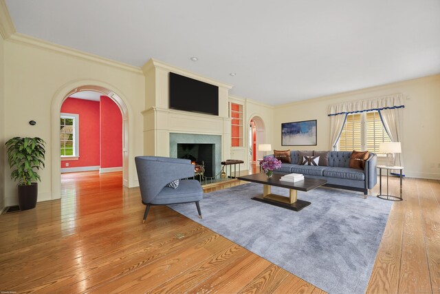 70 Sill Ln, Old Lyme, CT 06371 - living room with arched walkways, plenty of natural light, wood-type flooring, built in features, and ornamental molding
