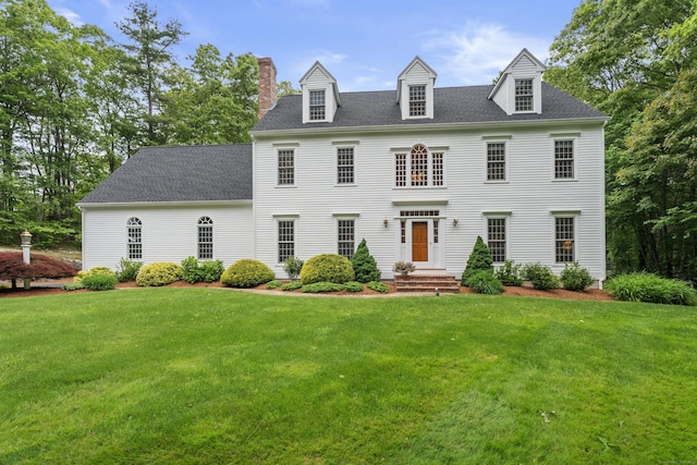 262 Fairview Rd, Westbrook, CT 06498 - view of front facade with a chimney, a front yard, and a shingled roof