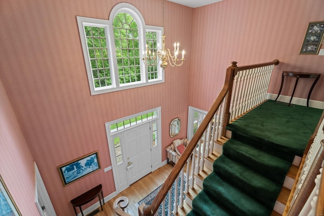 262 Fairview Rd, Westbrook, CT 06498 - entryway with a chandelier, wood finished floors, stairs, and a towering ceiling