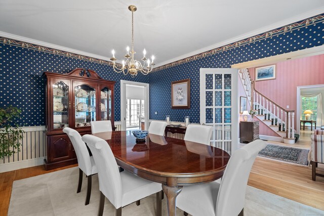 262 Fairview Rd, Westbrook, CT 06498 - dining room featuring wallpapered walls, crown molding, wood finished floors, a chandelier, and stairway