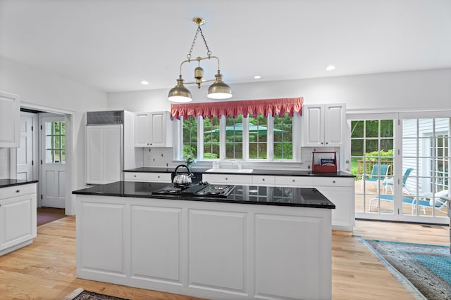 262 Fairview Rd, Westbrook, CT 06498 - kitchen featuring black electric stovetop, white cabinets, healthy amount of natural light, a kitchen island, and recessed lighting