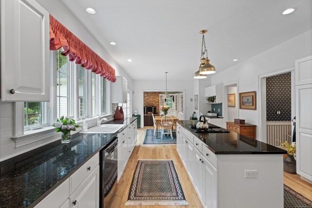 262 Fairview Rd, Westbrook, CT 06498 - kitchen with black appliances, a sink, light wood-type flooring, white cabinetry, and recessed lighting