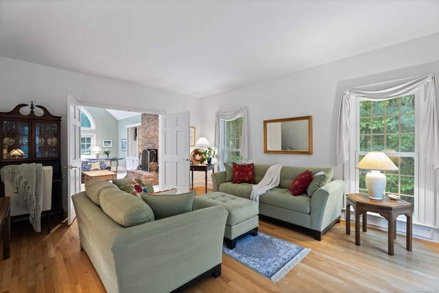 262 Fairview Rd, Westbrook, CT 06498 - living area featuring plenty of natural light, light wood finished floors, and a brick fireplace