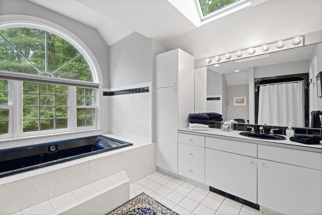 262 Fairview Rd, Westbrook, CT 06498 - full bathroom with a skylight, tile patterned floors, vanity, a bath, and vaulted ceiling