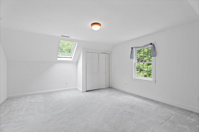 262 Fairview Rd, Westbrook, CT 06498 - unfurnished bedroom with carpet flooring, lofted ceiling, a skylight, baseboards, and a closet