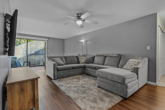 living area featuring ceiling fan, wood finished floors, and baseboards