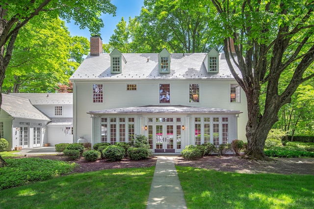 379 Hurlbutt St, Wilton, CT 06897 - view of front facade with a high end roof, a chimney, french doors, and a front lawn
