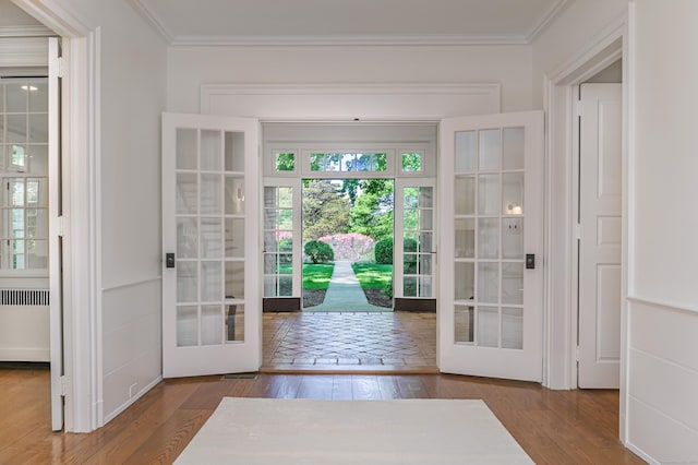 379 Hurlbutt St, Wilton, CT 06897 - doorway with french doors, radiator heating unit, crown molding, and wood finished floors