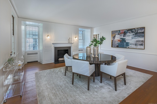 379 Hurlbutt St, Wilton, CT 06897 - dining space featuring a decorative wall, a fireplace with flush hearth, and wood finished floors