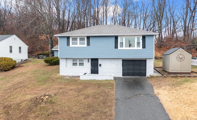 20 Rosengarten Dr, Waterbury, CT 06704 - view of front facade with asphalt driveway, a front yard, a garage, a shingled roof, and stone siding