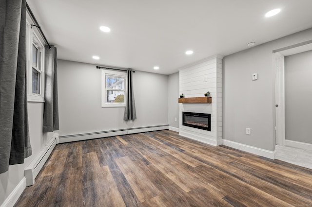 20 Rosengarten Dr, Waterbury, CT 06704 - unfurnished living room with a baseboard heating unit, recessed lighting, a fireplace, wood finished floors, and baseboards