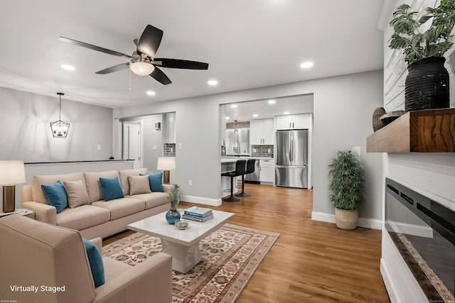 20 Rosengarten Dr, Waterbury, CT 06704 - living area featuring a glass covered fireplace, ceiling fan, light wood-style floors, recessed lighting, and baseboards