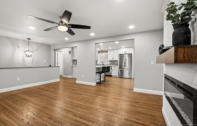 20 Rosengarten Dr, Waterbury, CT 06704 - unfurnished living room with a fireplace, recessed lighting, ceiling fan, wood finished floors, and baseboards