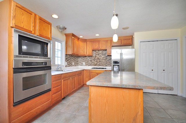 20 Nessa Way, Rocky Hill, CT 06067 - kitchen with appliances with stainless steel finishes, backsplash, light tile patterned flooring, a kitchen island, and a sink