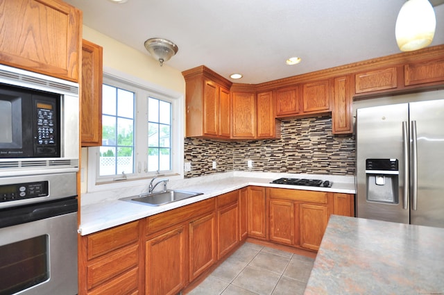 20 Nessa Way, Rocky Hill, CT 06067 - kitchen with appliances with stainless steel finishes, a sink, light tile patterned floors, brown cabinetry, and recessed lighting