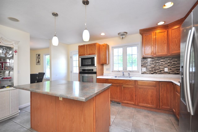 20 Nessa Way, Rocky Hill, CT 06067 - kitchen featuring appliances with stainless steel finishes, a sink, light tile patterned flooring, tasteful backsplash, and brown cabinetry
