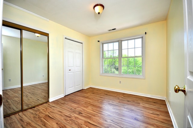 20 Nessa Way, Rocky Hill, CT 06067 - unfurnished bedroom with two closets, wood finished floors, and baseboards
