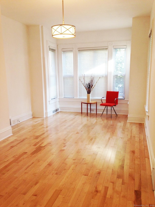 sitting room featuring light wood-type flooring and baseboards