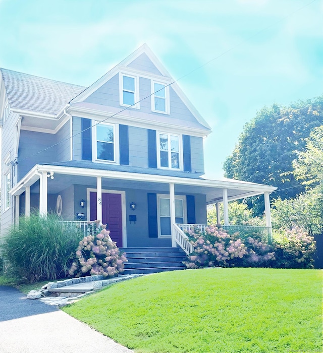 view of front of property featuring a porch and a front lawn