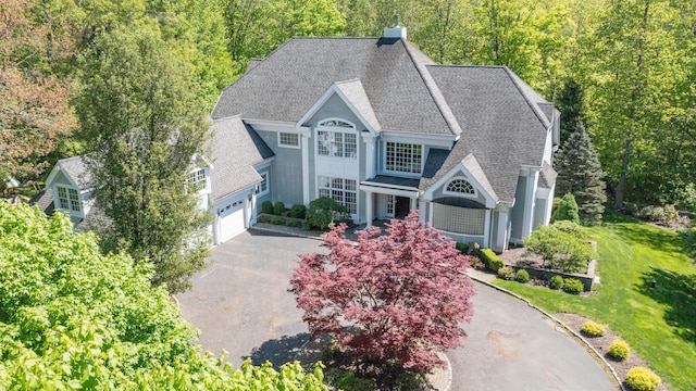14 Dillman Ct, Ridgefield, CT 06877 - view of front of property with driveway, a shingled roof, a view of trees, and a chimney