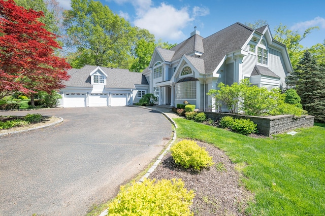 14 Dillman Ct, Ridgefield, CT 06877 - victorian home featuring asphalt driveway, a shingled roof, a chimney, a front yard, and a garage