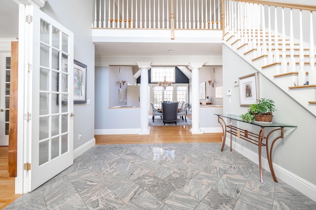 14 Dillman Ct, Ridgefield, CT 06877 - entrance foyer with ornate columns, a chandelier, ornamental molding, baseboards, and a towering ceiling