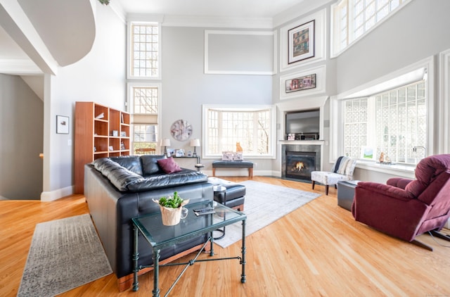14 Dillman Ct, Ridgefield, CT 06877 - living room with a towering ceiling, plenty of natural light, wood finished floors, a fireplace with flush hearth, and baseboards