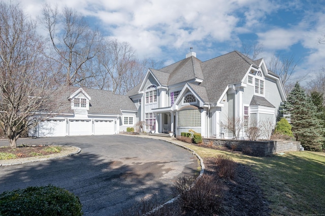 14 Dillman Ct, Ridgefield, CT 06877 - view of front of home featuring driveway, a chimney, a garage, roof with shingles, and a front yard