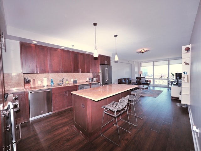 1 Broad St Unit 17C, Stamford, CT 06901 - kitchen featuring appliances with stainless steel finishes, dark wood-style floors, reddish brown cabinets, open floor plan, and tasteful backsplash