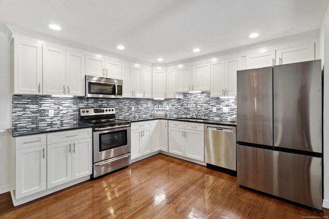 23 Poplar St, Norwalk, CT 06855 - kitchen with appliances with stainless steel finishes, a sink, dark countertops, and dark wood-style flooring