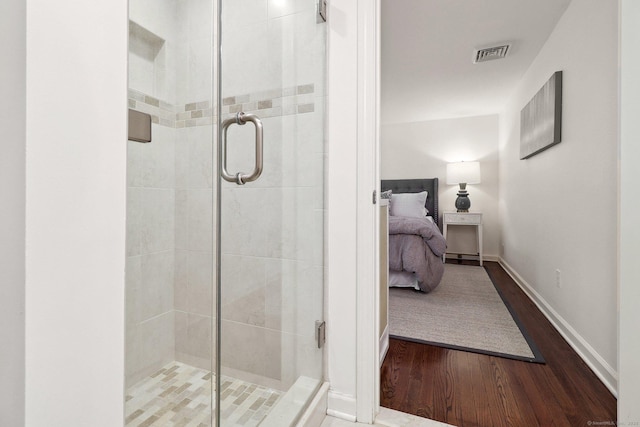 23 Poplar St, Norwalk, CT 06855 - bathroom featuring wood finished floors, a shower stall, connected bathroom, and baseboards