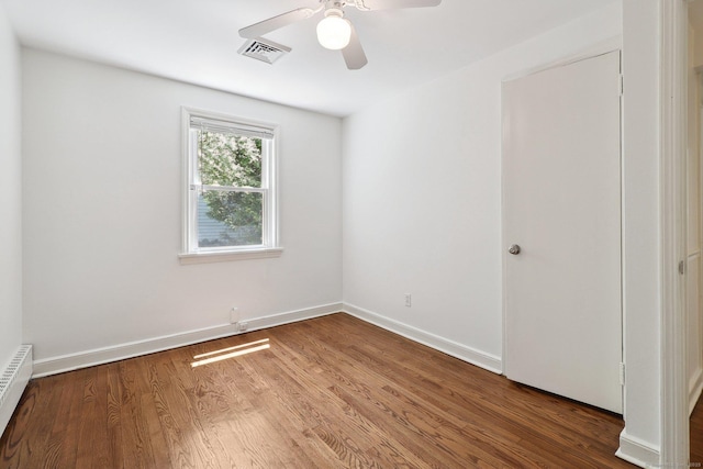 23 Poplar St, Norwalk, CT 06855 - unfurnished room with a baseboard heating unit, wood finished floors, a ceiling fan, and baseboards