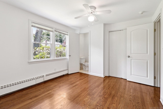 23 Poplar St, Norwalk, CT 06855 - unfurnished bedroom with a baseboard radiator, wood finished floors, a closet, connected bathroom, and a ceiling fan