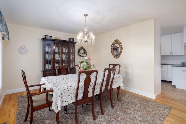 191 Pond View Dr, Watertown, CT 06795 - dining area featuring light wood-style floors, a chandelier, and baseboards