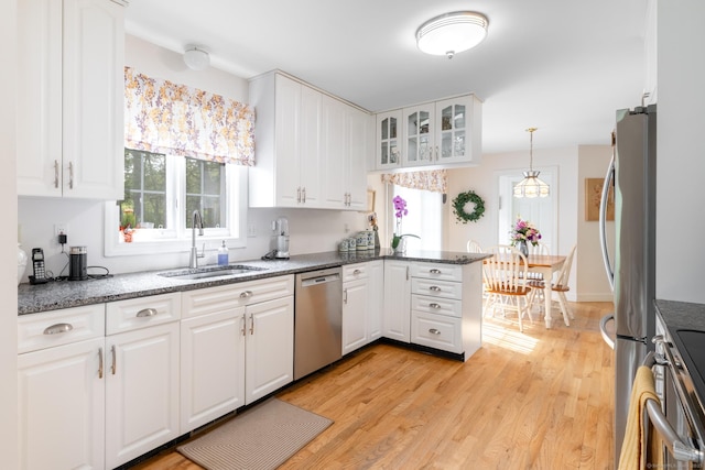 191 Pond View Dr, Watertown, CT 06795 - kitchen featuring appliances with stainless steel finishes, a sink, a peninsula, white cabinetry, and glass insert cabinets